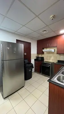 a kitchen with a stainless steel refrigerator and a sink at JBR Skyview Rooms in Dubai