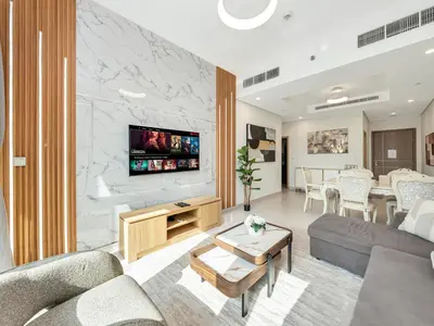 a living room with a couch and a table at Luxury 2BR near Burj Khalifa with Rooftop Pool, City & Canal Views, Free Parking in Dubai