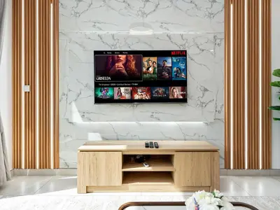 a living room with a tv on a wall at Luxury 2BR near Burj Khalifa with Rooftop Pool, City & Canal Views, Free Parking in Dubai