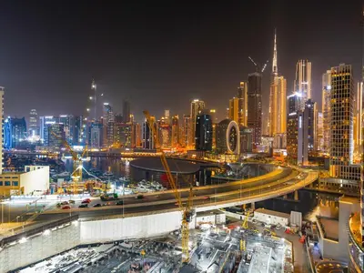 a view of a city at night with a freeway at Modern 1BR Near Burj Khalifa with Rooftop Pool, City & Canal Views, Free Parking in Dubai