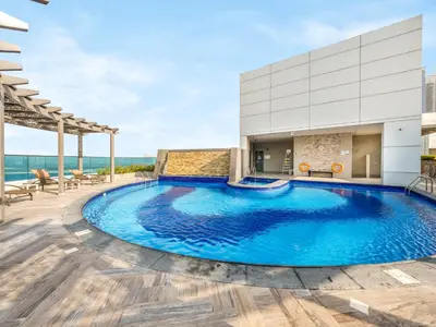 a swimming pool on the roof of a building at Modern 1BR Near Burj Khalifa with Rooftop Pool, City & Canal Views, Free Parking in Dubai