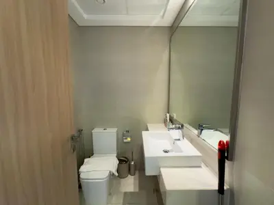 a bathroom with a toilet and a sink and a mirror at Luxe Studio Vibes Stylish & All New Pet Free in Dubai