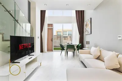 a living room with a couch and a tv at Bookable -1 Bed Rukan Townhouse with Clubhouse Access in Dubai
