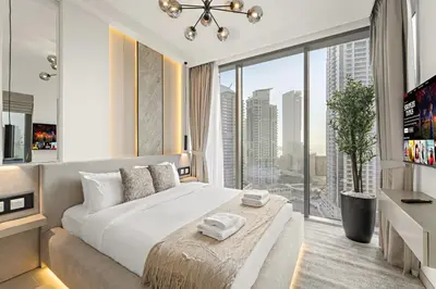 a bedroom with a large bed and a large window at Luxe 2BR with Marina Views l Gaming & Music Room in Dubai
