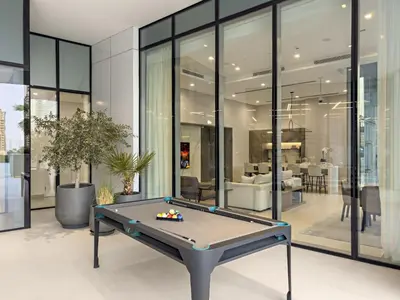 a ping pong table in the middle of a room at Luxe 2BR with Marina Views l Gaming & Music Room in Dubai