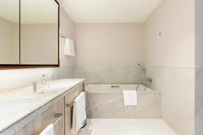 a bathroom with a tub and a sink and a mirror at Iconic 3BHK I Stunning Creek Views I Sleep up to 6 guests I High Floor I Pool I Free Parking I Pet Friendly I in Dubai