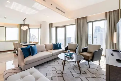a living room with a couch and a table at Iconic 3BHK I Stunning Creek Views I Sleep up to 6 guests I High Floor I Pool I Free Parking I Pet Friendly I in Dubai