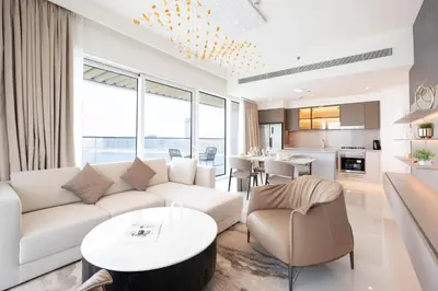 a living room with a couch and a table at Keyrock - Emaar Beachfront Apartment with Sea & Palm Jumeirah Views in Dubai