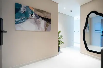 a large mirror on a wall in a room with at Keyrock - Emaar Beachfront Apartment with Sea & Palm Jumeirah Views in Dubai