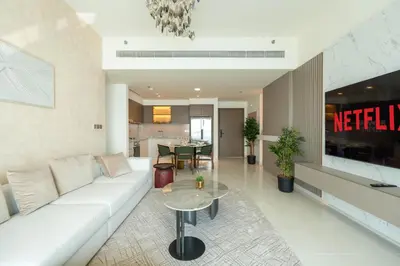 a living room with a white couch and a table at KeyRock - Dreamy Stay with Palm View - Emaar Beach in Dubai