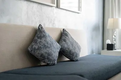 two pillows sitting on top of a couch at TRPS - Maison Mall Street, Downtown - Beautifully Appointed 1BR, Near to Burj Khalifa in Dubai