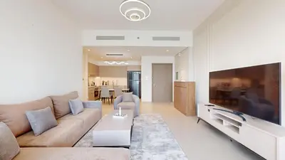 a living room with a couch and a flat screen tv at Exclusive Burj Khalifa View Luxury 2BR Next to Dubai Mall - Like Home in Dubai