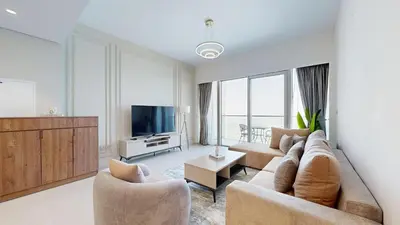 a living room with a couch and a television at Exclusive Burj Khalifa View Luxury 2BR Next to Dubai Mall - Like Home in Dubai