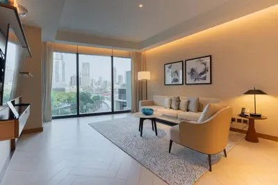 a living room with a couch and a table at TRPS - Address Opera, Downtown - Burj Khalifa View, Luxury 3BR Living in Dubai
