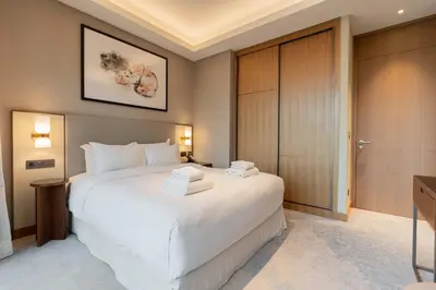 a bedroom with a large white bed in a room at TRPS - Address Opera, Downtown - Burj Khalifa View, Luxury 3BR Living in Dubai