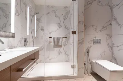 a bathroom with a shower and a toilet and a sink at TRPS - Address Opera, Downtown - Burj Khalifa View, Luxury 3BR Living in Dubai
