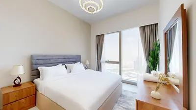 a bedroom with a white bed and a large window at Panaromic Burj Khalifa View from Balcony - Luxury 2BR next to Dubai Mall - Like Homes in Dubai