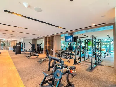 a gym with treadmills and exercise equipment in a building at Panaromic Burj Khalifa View from Balcony - Luxury 2BR next to Dubai Mall - Like Homes in Dubai
