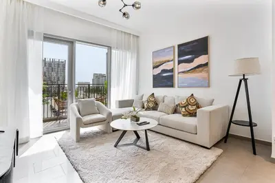 a white living room with a couch and a table at Radiant 2BR APT near Dubai Hills Park & Golf Club in Dubai