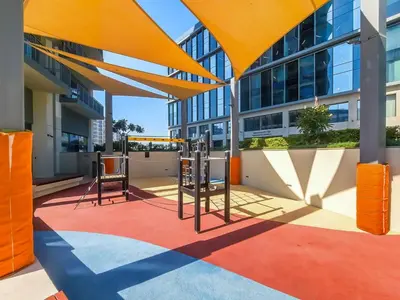 a playground in front of a building at Radiant 2BR APT near Dubai Hills Park & Golf Club in Dubai