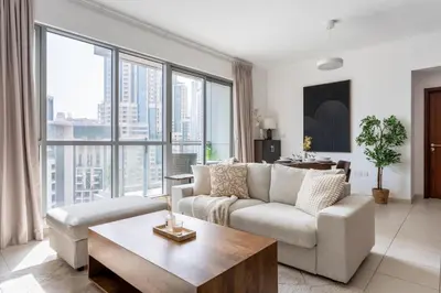 a living room with a couch and a table at GuestReady - Downtown View | 1BR + Sofa Bed in Dubai