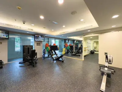 a gym with several treadmills and exercise bikes at GuestReady - Downtown View | 1BR + Sofa Bed in Dubai