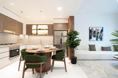 a kitchen and living room with a table and chairs and a couch at KeyRock - Palm View Luxury Stay in Grand Bleu in Dubai
