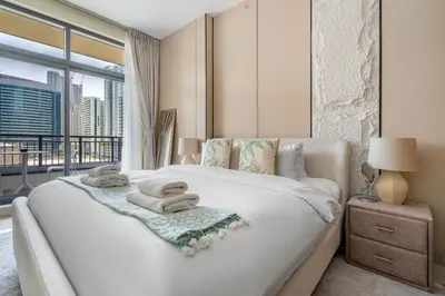 a bedroom with a large bed with towels on it at DAYF-CLA Stylish Apartment for 4 Guests in Central Location in Dubai