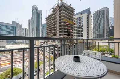 a table on a balcony with a view of a city at DAYF-CLA Stylish Apartment for 4 Guests in Central Location in Dubai