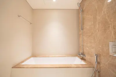 a bathroom with a bath tub and a shower at KeyRock - Grand Bleu Escape with Iconic Palm Views in Dubai