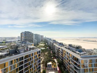 an aerial view of a city and the beach at Brand New High Floor Studio in Midtown Dubai in Dubai