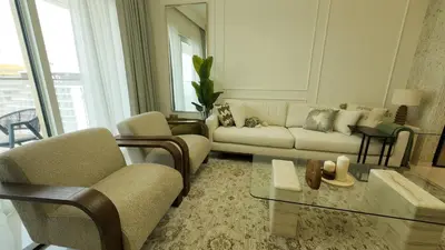 a living room with a couch and chairs and a table at Elegant Seaside Luxury 1BR in Beachfront, Grand BLeu Tower, Pool & Gym in Dubai