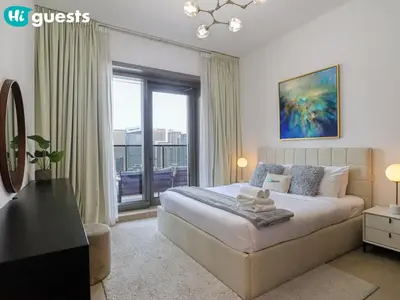 a bedroom with a bed and a large window at HiGuests - Marina View 1 BR with Spacious Balcony in Dubai