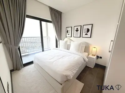 a bedroom with a white bed and a large window at Lux - 2BR - Spacious - Burj Khalifa View - New Bld in Dubai