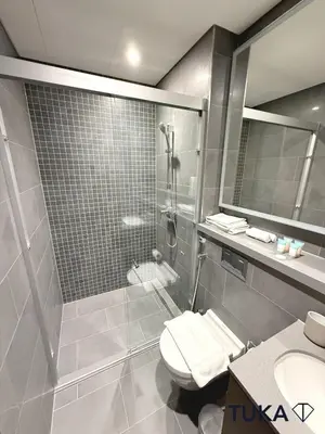 a bathroom with a shower and a toilet and a sink at Lux - 2BR - Spacious - Burj Khalifa View - New Bld in Dubai