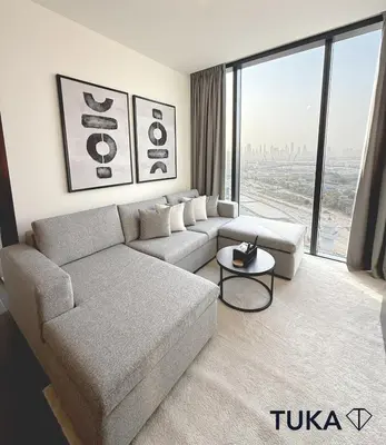 a living room with a couch and a large window at Lux - 2BR - Spacious - Burj Khalifa View - New Bld in Dubai