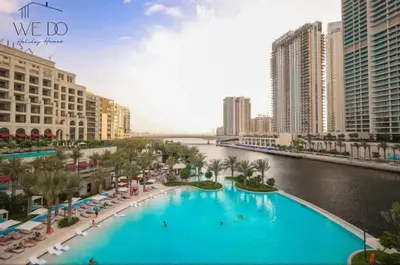 a large swimming pool in a city with a river at Luxury Apartment in CREEK Harbour in Dubai