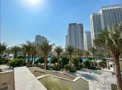 a view of a resort with palm trees and buildings at Luxury Apartment in CREEK Harbour in Dubai
