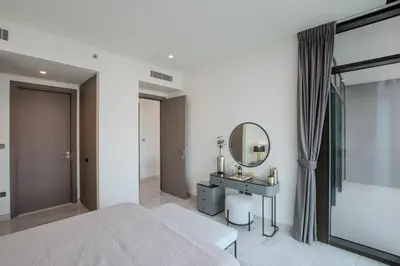 a bedroom with a bed and a mirror and a sink at Hububb Luxury Peninsula 5 Dubai in Dubai