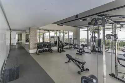 a gym with a lot of treadmills and machines at Beach Vista - One Bed with Infinity Pool Access in Dubai