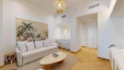 a living room with a couch and a table at Al Dabas 2 - Calm One Bedroom in Palm Jumeirah in Dubai