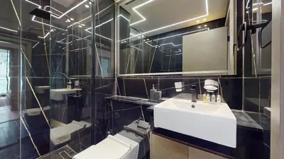 a bathroom with a white sink and a mirror at Binghatti Crescent - Two Bed with Pool View in JVC in Dubai