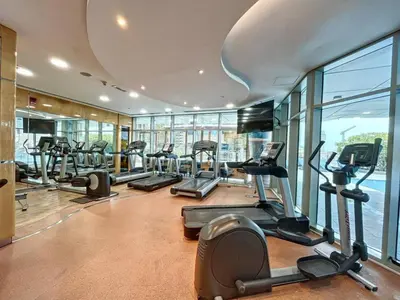 a gym with treadmills and ellipticals in a building at Ocean Heights - Upgraded Two Bed with Sea View in Dubai