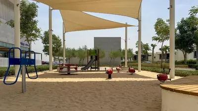 a playground with children playing in a sandbox at Maison Privee - Stylish Studio with Top Facilities in Damac Hills in Dubai