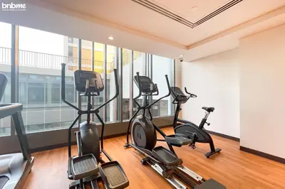 a gym with treadmills and elliptical machines at bnbmehomes - Afnan 4 - Midtown in Dubai