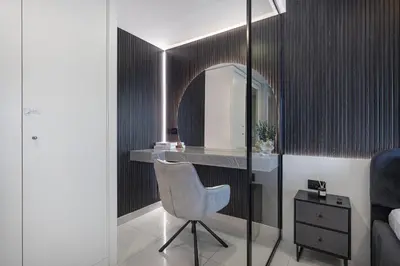a room with a chair and a mirror and a bed at Restay Homes at Damac Maison Mall - Full Burj View from all rooms - 1 min to Dubai Mall in Dubai