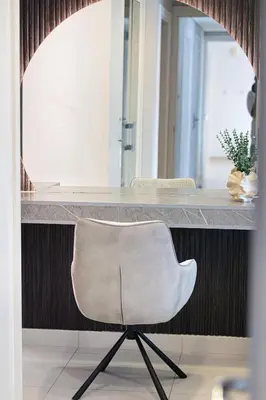 a white chair sitting at a counter in a room at Restay Homes at Damac Maison Mall - Full Burj View from all rooms - 1 min to Dubai Mall in Dubai