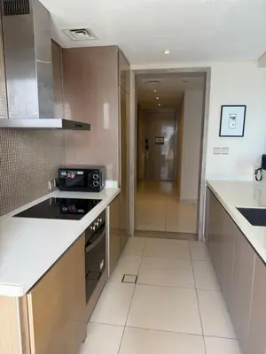 a kitchen with a stove and a counter top at 2BR Apartment in Paramount Hotel with Burj Khalifa View in Dubai