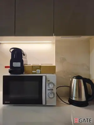 a microwave with a coffee pot on top of it at EGATE - Studio - 4th Floor - Balcony with a View - 20-423 in Dubai
