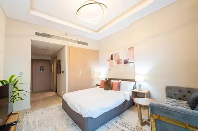 a bedroom with a bed and a couch at EasyGo- City Center, Spacious, Skyline view in Dubai